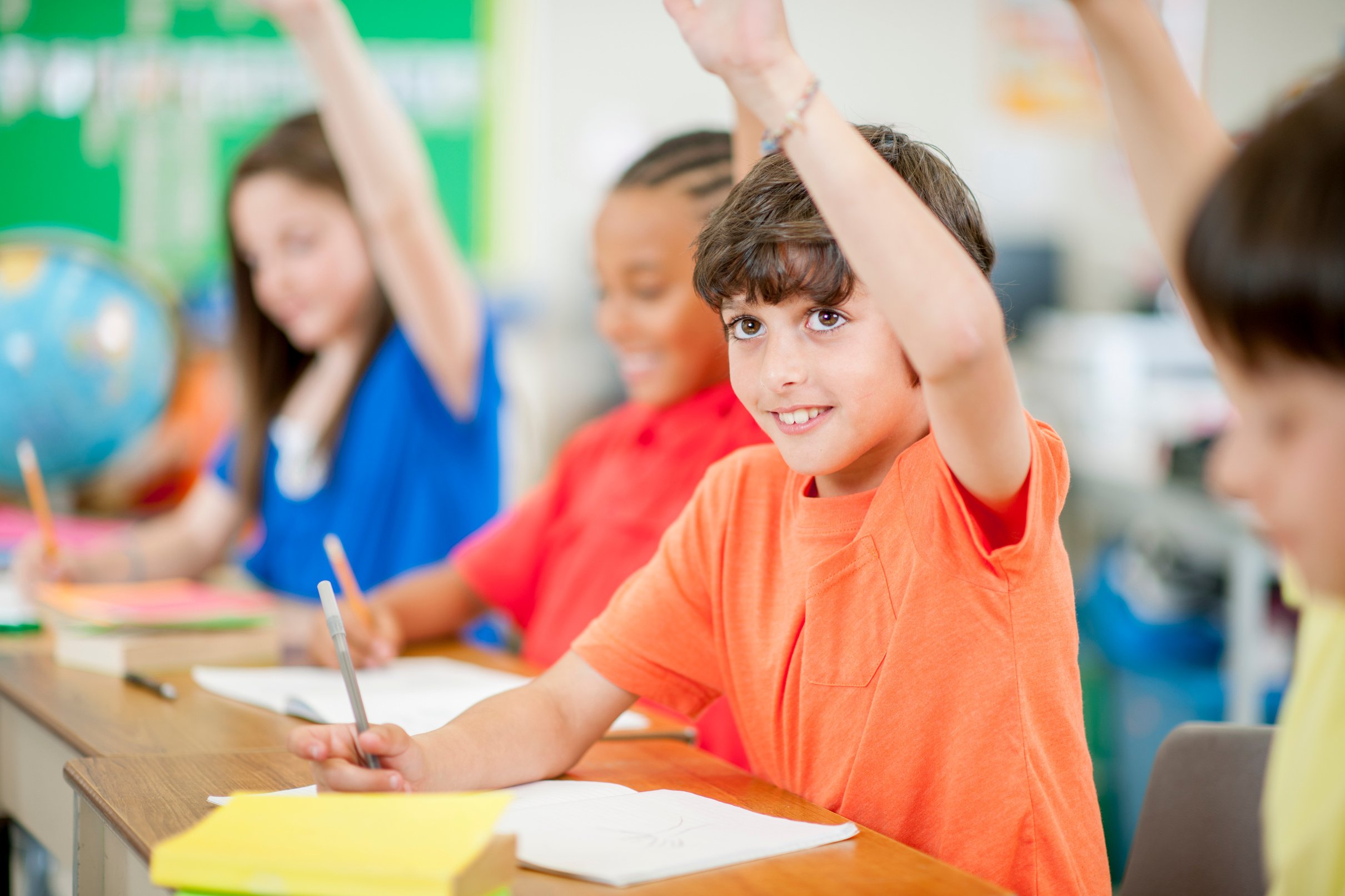 Young Students Raising their Hands